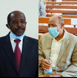 Two side by side photos of Paul Rusesabagina wearing a black suit with a red tie and a grey suit without a tie as he wears a mask during Rwandan court proceedings during his illegal detention.